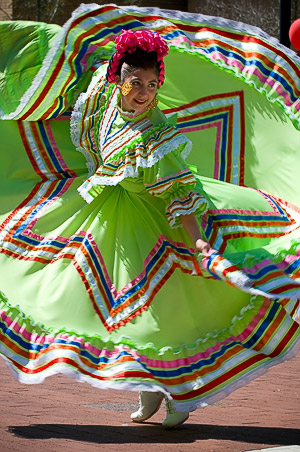 Woman in twirls in a traditional dress.
