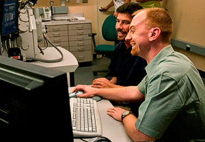 Ted Acworth and David Diercks working at a computer.