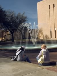 Students relax on the steps situated around the new UNT fountain