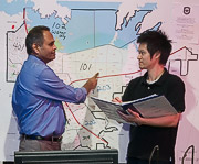Ram Dantu and student in front of a map