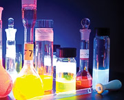 Grouping of test tubes, viles and droppers with vivid artistic color and lighting
