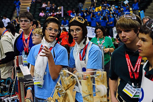 Students wearing antique aviator flying caps, goggles and scarves compete at the BEST robotics competition.