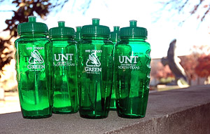 U.N.T. plastic water bottles grouped together with the eagle statue in the background.
