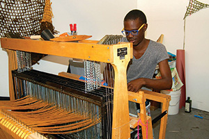 Diedrick Brackens ('11) works on his loom. (Photo by Sofia V. Gonzalez)