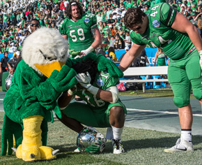 Scrappy consoles a player after a tough loss at the 2016 Heart of Dallas Bowl (Photo by Ahna Hubnik)