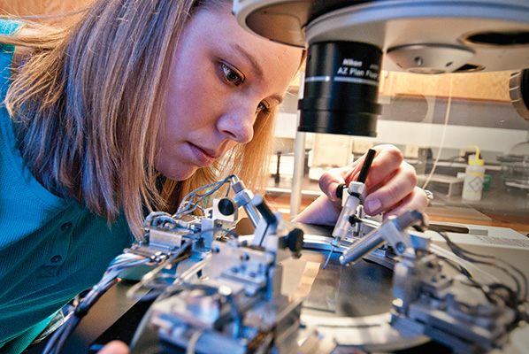 Kristina Clemons works with the nanomanipulator developed by Guido Verbeck, associate professor of chemistry. (Photo by Jonathan Reynolds)