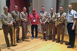 Pictured from left are Master Sgt. Doug Morgan ('96), baritone saxophone; Technical Sgt. Ben Polk ('08), bass trombone; Master Sgt. Ben Patterson ('96), lead trombone; Rheault; Master Sgt. Jeff Martin, trombone; Master Sgt. Andy Axelrad, alto sax; Master Sergeant (select) Tyler Kuebler ('95, '97 M.M.), alto sax and music director; and Master Sgt. Blake Arrington ('02, '04 M.M.), clarinet with concert band and Honor Flight Liaison for the group's visit with the U.S. Air Force band.