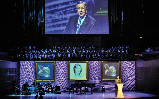 Sportscaster and announcer Brent Musburger presents an alumni award to Phyllis George during the 2014 Emerald Eagle Honors event held at the Morton H. Meyerson Symphony Center in Dallas. (Photo by Michael Clements)
