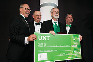 Richard Rogers, Regents Professor of psychology, second from right, receives the Eminent Faculty Award cash prize from President Neal Smatresk, UNT Foundation board member Bob Sherman, and Faculty Senate chair and finance professor James Conover. (Photo by Gary Payne)