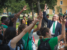 President Neal Smatresk shares his Mean Green pride and greets students with the Eagle Claw on the first day of fall classes. (Photo by Michael Clements)