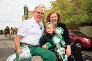 President Neal Smatresk and Debbie Smatresk ride in the UNT Homecoming Parade with their granddaughter. (Photo by Gary Payne)