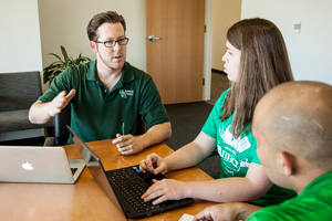UNT seniors Adam Sharpe, Elizabeth Adams and Erick Cordova discuss their class project that paired them with a Dallas-Fort Worth area business. The three were part of a team that helped the business find logistics solutions, and gave the College of Business students hands-on experience. (Photo by Ahna Hubnik)