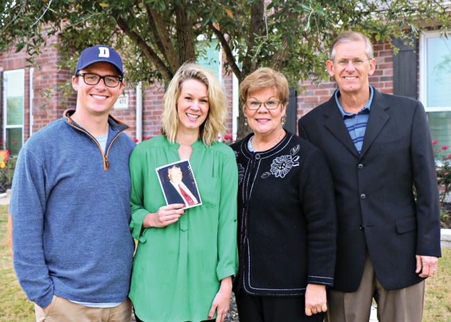 From left, Zach Scheer ('10), Gina Grant Scheer ('10), Liz Millender Grant ('78, '81 M.M.) and Ross Grant ('78, '78 M.M.Ed., '89 Ph.D.). Gina is holding a photograph of her grandfather, Charles Millender ('57, '75 M.M.). (Courtesy of Liz Grant)