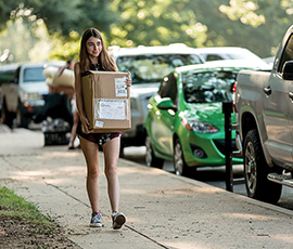 A student moves into her residence hall at UNT.