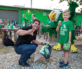 Join the UNT Alumni Association for family-friendly events like this spring's Coaches Caravan where Mean Green head football coach Seth Littrell met UNT fan Lukas Kamenicky.