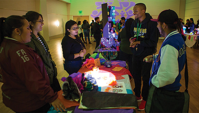UNT students painted sugar skulls as part of the Dia de los Muertos celebration on campus Oct. 31. The festival in the University Union featured altars with ofrendas made by different student organizations. (Photo by Kara Dry)