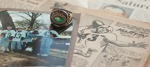 Cecil &ldquo;Zeke&rdquo; Martin's ('51,'51 M.Ed.) North Texas Athletic Hall of Fame ring amid memorabilia and  a photo of his five grandsons, all wearing his North Texas jersey No. 43. (Photo by Angilee Wilkerson)