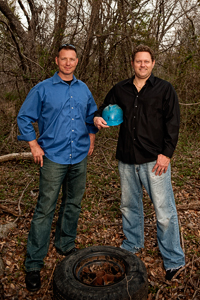 Tim Sommers (&rsquo;98) and Eric Baumgart work to clean up scrap tire materials from illegal tire dumps through their environmental cleanup company TERC LLC. (Photo by Angilee Wilkerson)