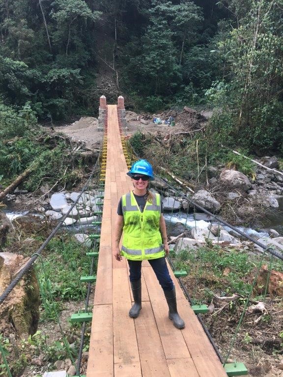 Sara Cederburg stands on a completed footbridge