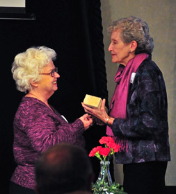 Chemistry faculty member Diana Mason, left, presents a brick from Masters Hall to Catherine Dawson, granddaughter of W.N. Masters.