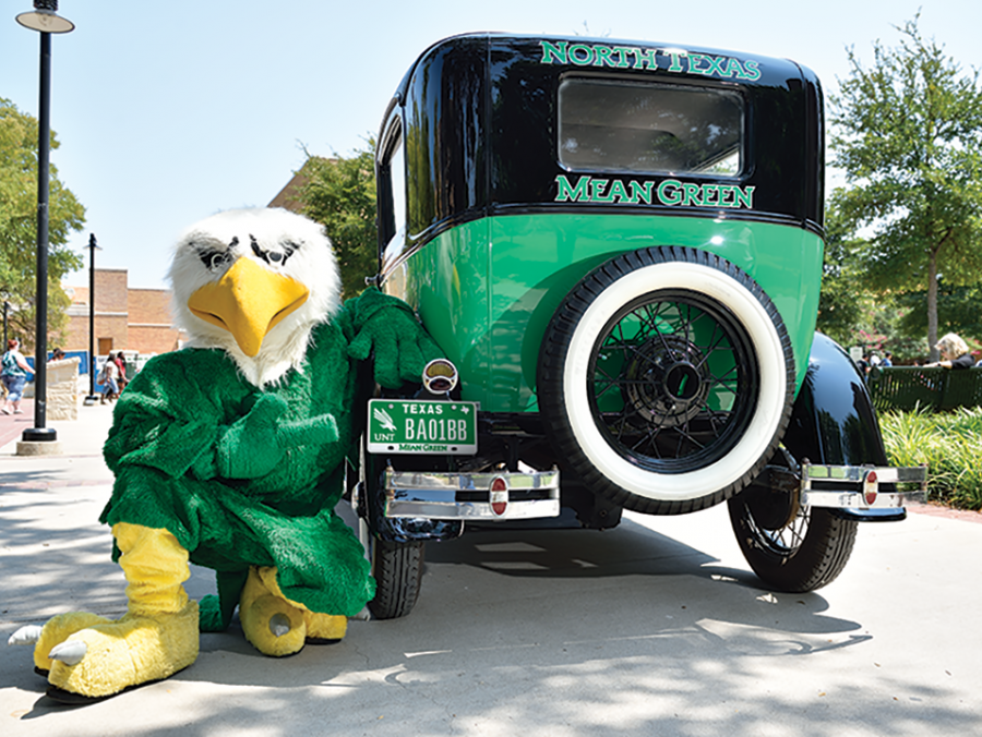 UNT mascot Scrappy poses with a UNT Model T car with UNT license plate