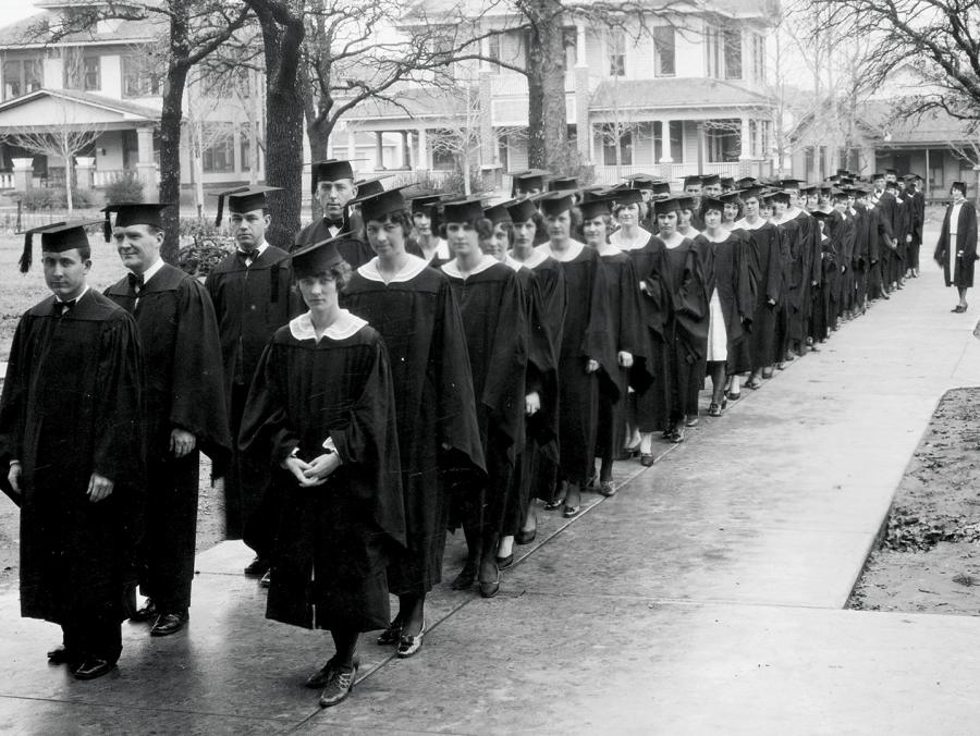 Graduates line up on campus in the 1920s.