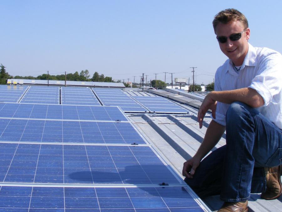James Clayton Lane sitting on top of solar panels