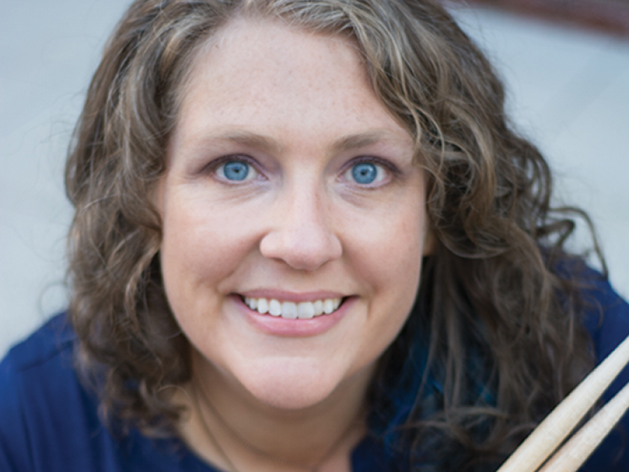 Michelle Schusterman holding a snare drum and drumsticks