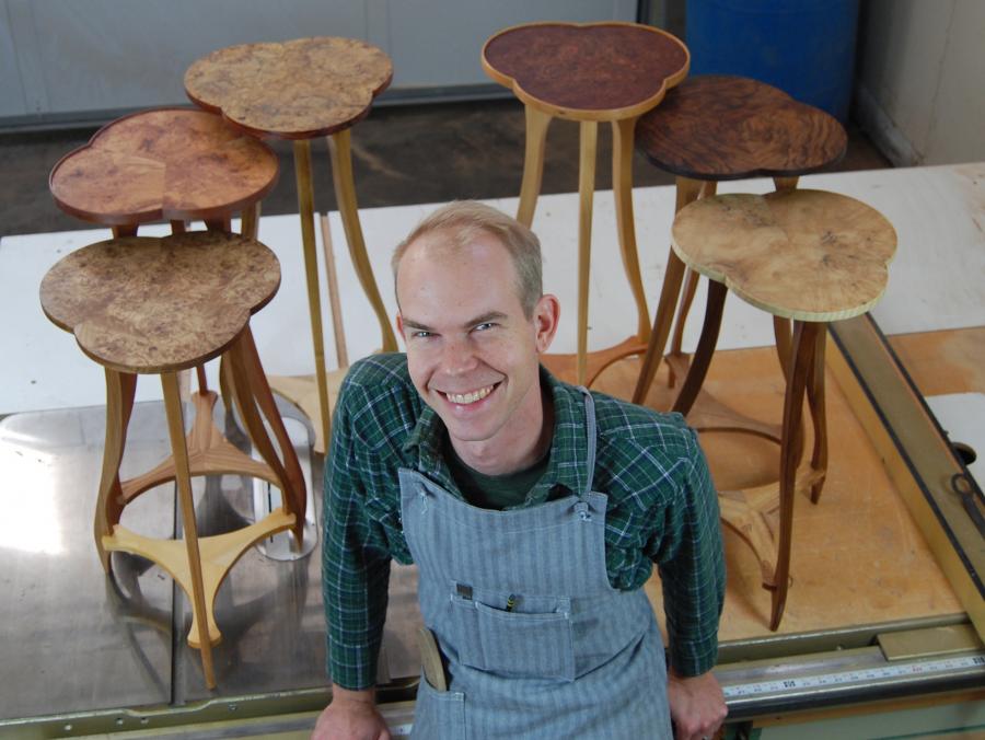 Austin Heitzman in front of handmade furniture
