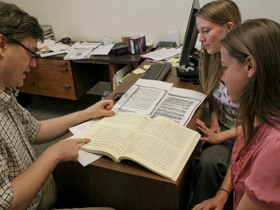 Professor Schulze reading book with students 
