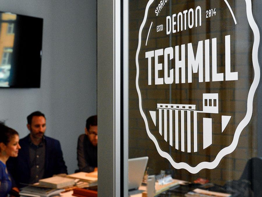 Denton Techmill door with a meeting in progress