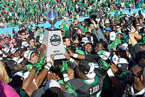 Mean Green football players celebrate at the Heart of Dallas Bowl (Photo by Michael Clements)