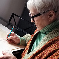 Photo of Teel Sale drawing on a table 