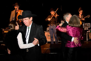 Couples dancing with a country and western band in the background