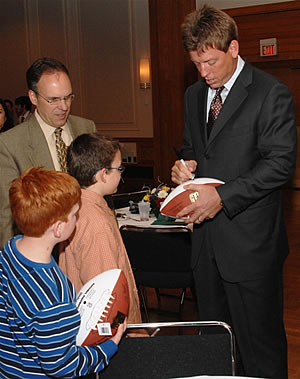 Troy Aikman signing football