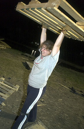 Student lifting wood