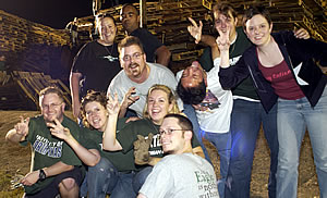 North Texas alumni practice the eagle claw at the bonfire site.