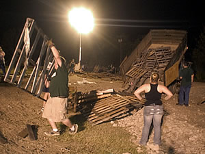 Students unload wood from a truck