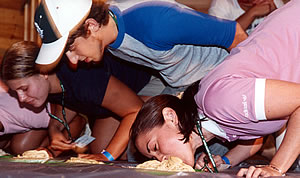 Freshmen eating spaghetti off of the floor