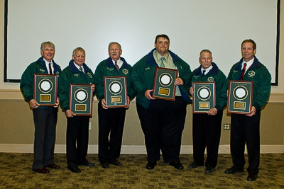 Six wrestlers display their award plaques.