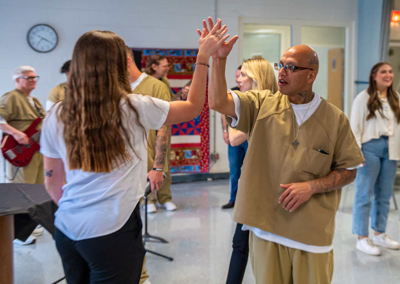 Inside and outside students interact with each other on graduation night.