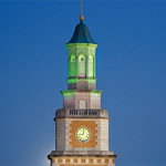 Clock tower illuminated in green light