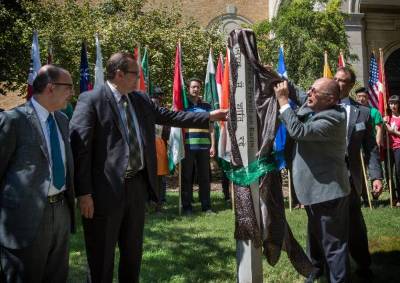 From left, José Octavio Tripp, consul general of Mexico in Dallas and dean, Consular Corps of Dallas/Fort Worth; Jamie Wilson ('01, '03 M.S., '11 Ph.D.), superintendent, Denton ISD; and Bob Brown, vice president of finance and administration, unveil the Peace Pole. (Photo by Ahna Hubnik)