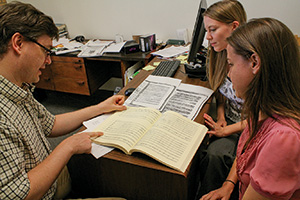 Hendrik Schulze, assistant professor of music history, works with students on the "Vespers of 1610" project. (Photo by Stephen Lucas)
