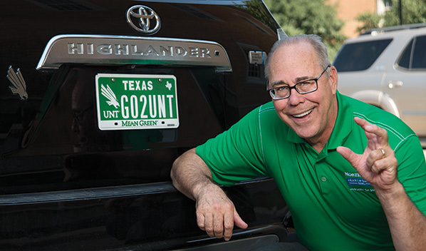 UNT president Dr. Neil Smatresk proudly displays a Go 2 UNT license plate. (Photo by Ahna Hubnik)