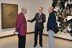 College of Visual Arts Dean Robert Milnes, middle, visits with Morton Prager, left, and artist Howard Sherman ('06 M.F.A.), right, at the opening of UNT ArtSpace Dallas. Dana Tanamachi's ('07) work hangs at left, Sherman's work at right. (Photo by Michael Clements)
