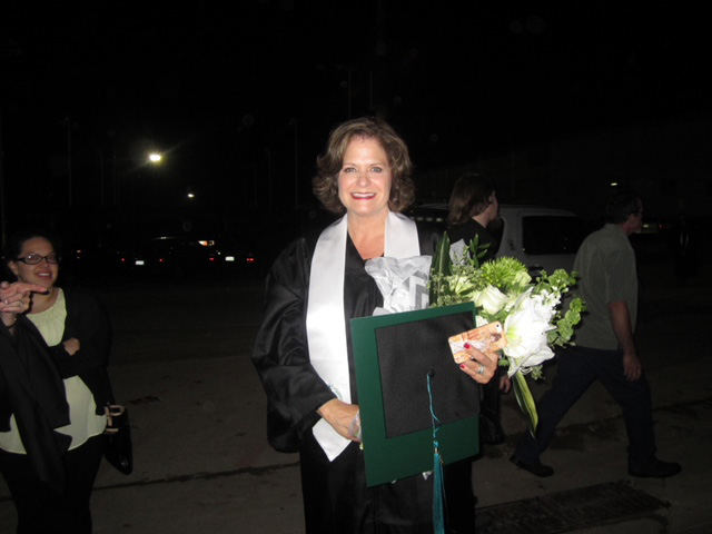 Janet Bracken at commencement in cap and gown regalia