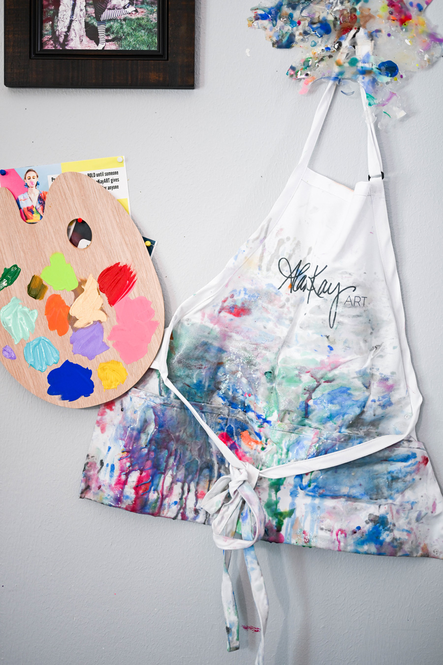 art paint mixing palette and apron artistically smudged with paint