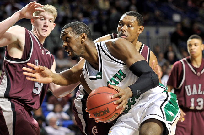 UNT senior forward George Odufuwa drives to the basket during the Sunbelt Conference Championship Tournament men's final game between University of North Texas and University of Arkansas at Little Rock. (Photo by Michael Clements)