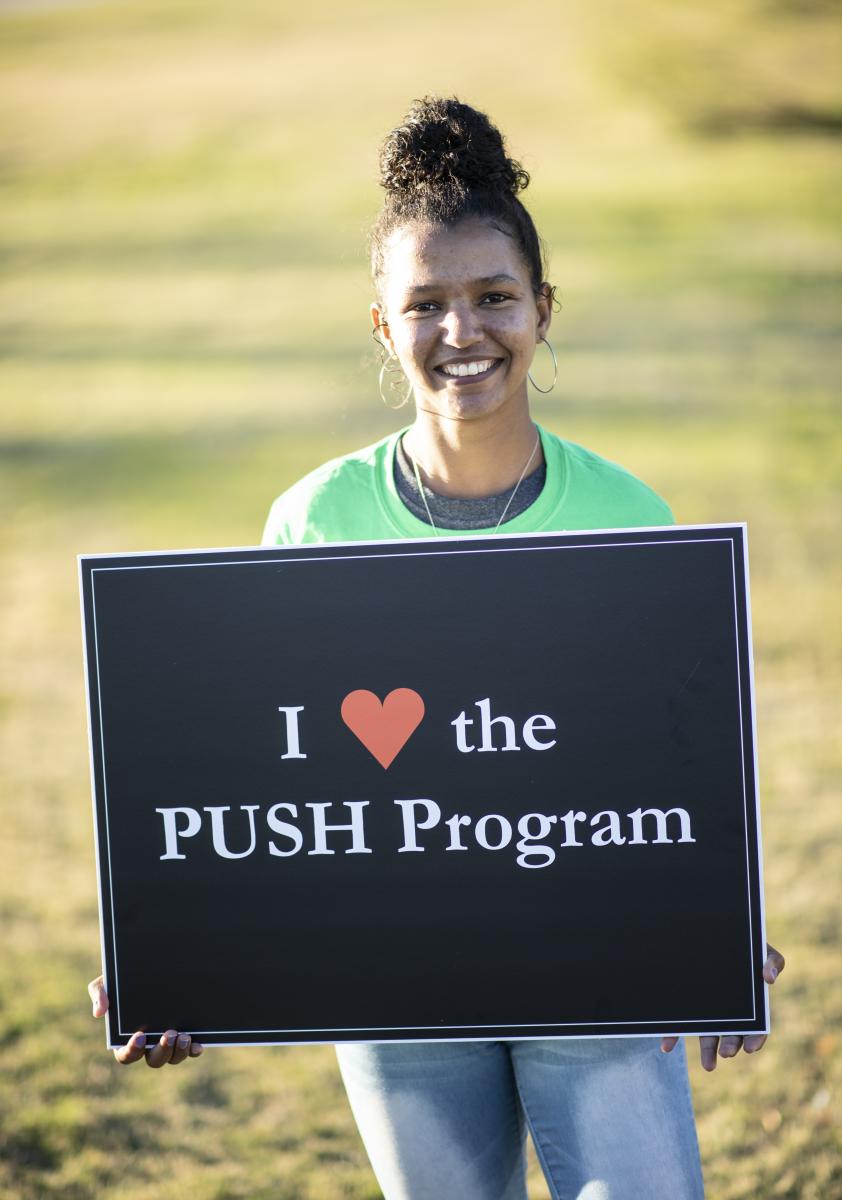 Photo of Tiblets Abreha holding sign saying "I heart the PUSH Program"